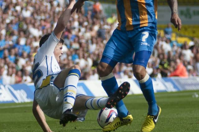 Sam Byram tackles Shrewsbury's Mark Wright on his competitive debut for Leeds United.