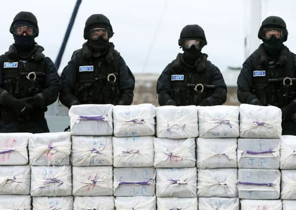 Members of the navy stand behind cocaine taken from onboard the yacht Makayabella