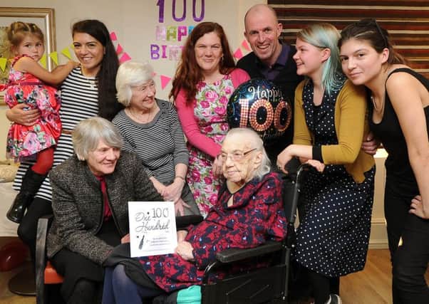Mona Collins celebrating her 100th birthday with daughter  Jean Carroll (left) and family