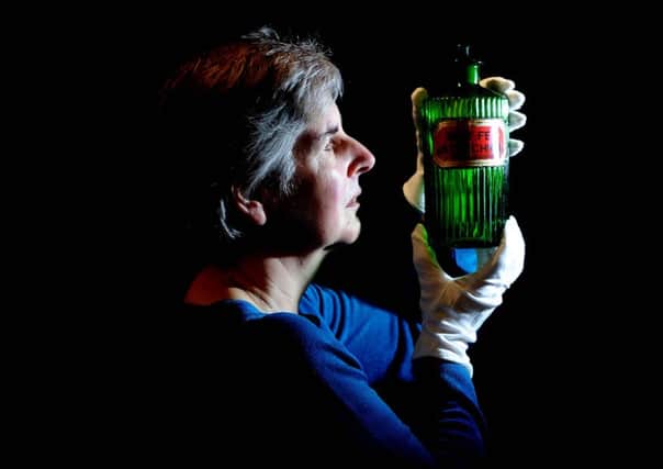 Kitty Ross, Curator of Social History at Abbey House Museum, Leeds, holding a chemist poison bottle of Strychnine. Picture: James Hardisty.