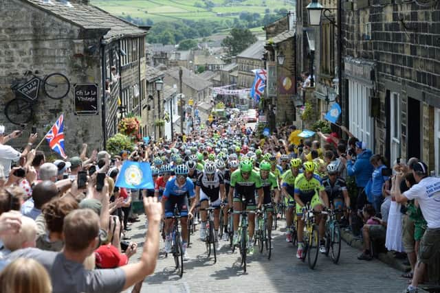 The Tour de France peleton passing through Haworth