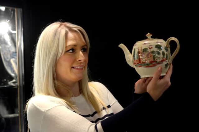 Tina Hooper holding a c1790 Leeds Creamware teapot made by Leeds Pottery  and handpainted  from the Cochrane collection valued at Â£1095 on the Roger de Ville Antiques stand from Derbyshire  at the Pavilions of Harrogate Antique and Fine Art Fair . PIC: Gary Longbottom