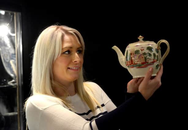Tina Hooper holding a c1790 Leeds Creamware teapot made by Leeds Pottery  and handpainted  from the Cochrane collection valued at Â£1095 on the Roger de Ville Antiques stand from Derbyshire  at the Pavilions of Harrogate Antique and Fine Art Fair . PIC: Gary Longbottom