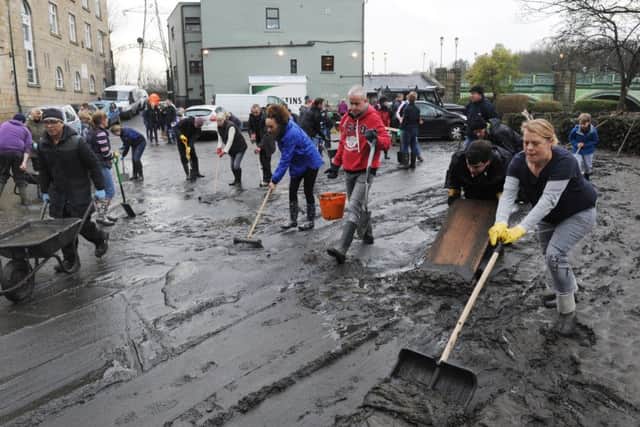 Volunteers clear the mud from the Kirkstall Bridge pub after the floods.