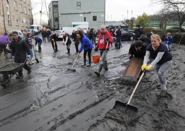 Volunteers clear the mud from the Kirkstall Bridge pub after the floods.