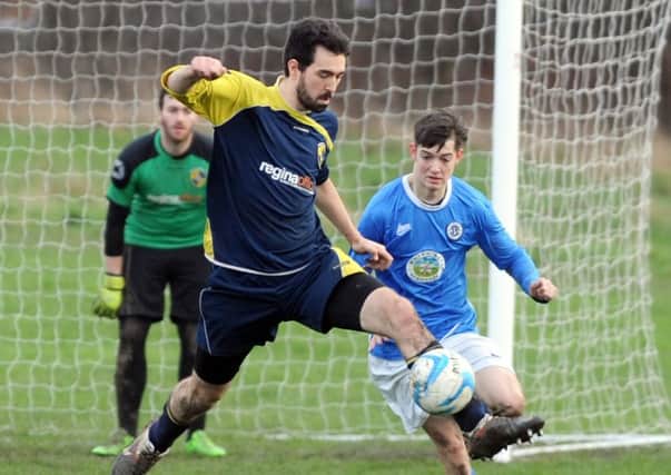 Craig Thomas of Dewsbuy Rangers FC gets ahead of Alex Bannan  of Calverley