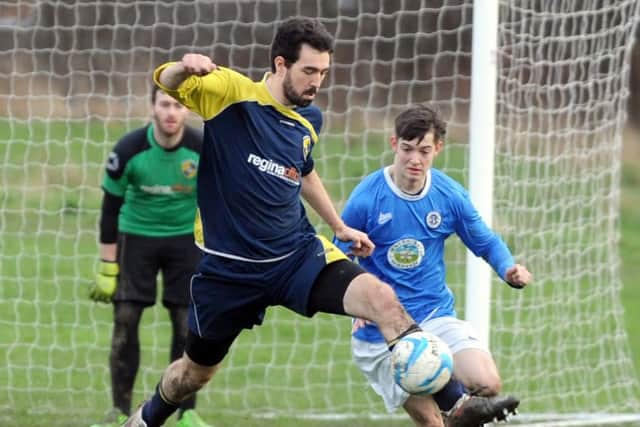 Craig Thomas of Dewsbuy Rangers FC gets ahead of Alex Bannan  of Calverley