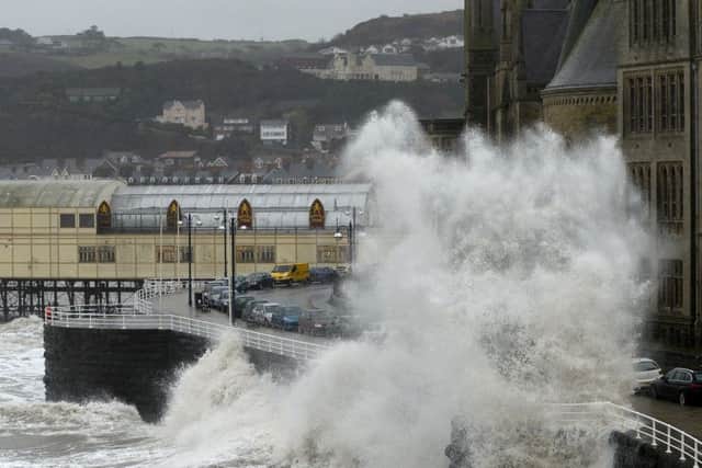 Waves crash against the the promenade in Aberystwyth as huge swathes of the UK are braced for a deluge of rain which could pour more misery on communities still reeling from flooding after Christmas.
