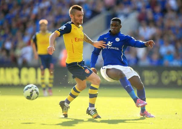 Arsenal's Mathieu Debuchy (left) and Leicester City's Jefferey Schlup (right) in Premier League action.