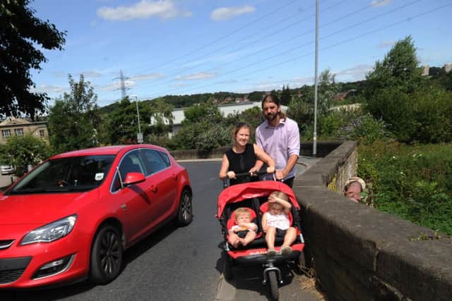 John and Anita Dorsett with there children Aidan aged 10 months and Erin aged 3, struggle to get through on the narrow footpaths at Wyther Lane, Leeds.SH1001647c..21st July 2014 Picture by Simon Hulme