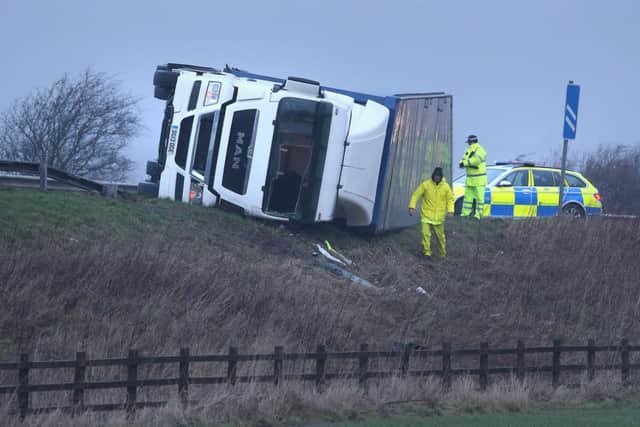 Police at the scene of an overturned lorry on the M9 near Falkirk as winds of more than 90mph have hit the west of Scotland as Storm Gertrude sweeps the country