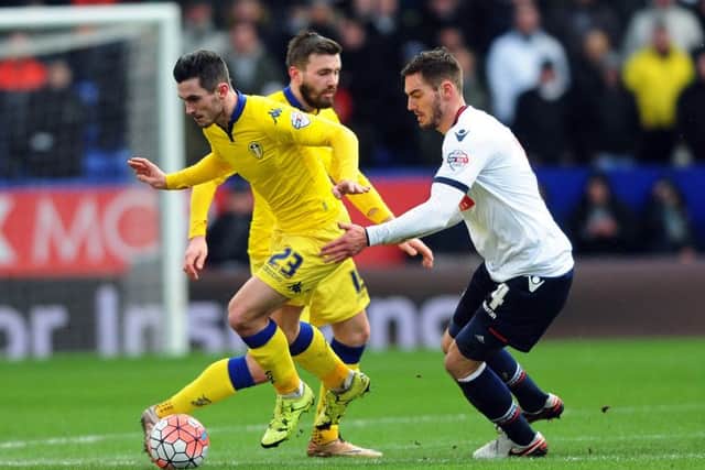 Lewis Cook gets away from Bolton's Dorian Dervite.