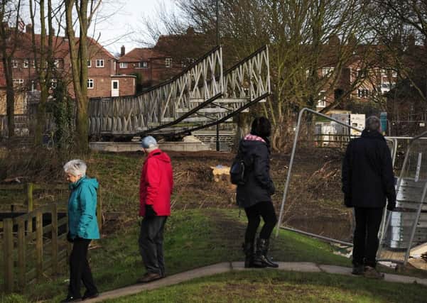 BRIDGING THE GAP: Locals survey the new temporary crossing. PIC: PA