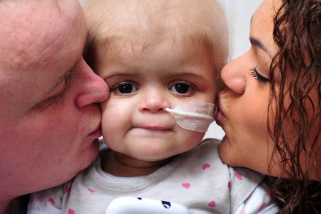 Parents Damion Sutcliffe and Amie Mills pictured last year with their late daughter Skye Sutcliffe, who passed away in December. Picture by Tony Johnson.