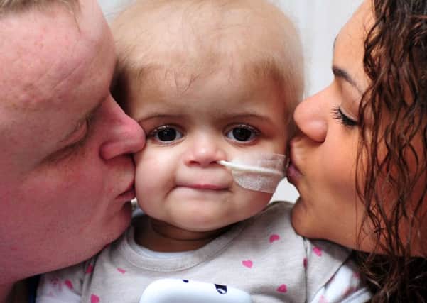 Parents Damion Sutcliffe and Amie Mills pictured last year with their late daughter Skye Sutcliffe, who passed away in December. Picture by Tony Johnson.