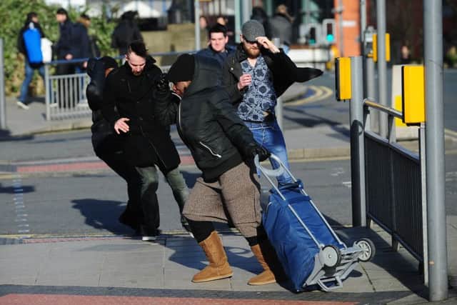 People struggle to cross the road close to Bridgewater Place in Leeds, during the high winds. 29th January 2016. Picture Jonathan Gawthorpe.