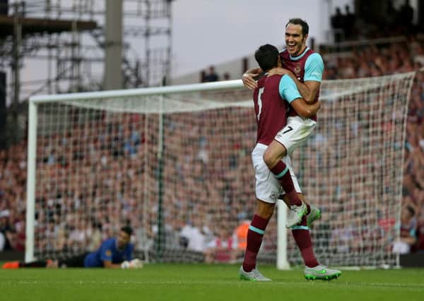#WHUFC's James Tomkins (left) celebrates a goal with teammate Joey O'Brien.