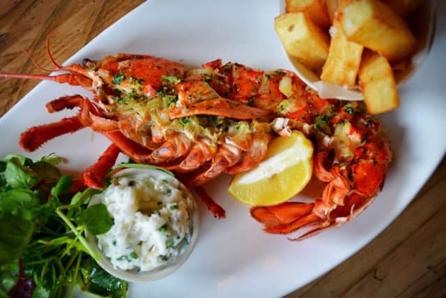 Half grilled North Sea lobster with garlic butter, fries and fennel and kohl rabi slaw.