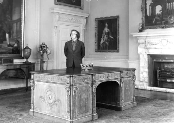 Leeds.  31st August 1973

Mr. Christopher Gilbert, the Keeper of Temple Newsam House, with the Â£43,000 Chippendale table on show there.