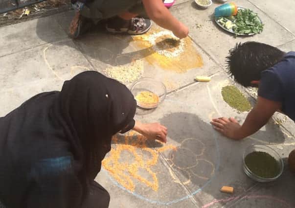 Youngsters doing Rangoli, an ancient Indian art form, with the charity.