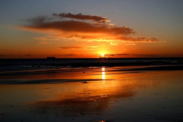Calm before the storm? Ships are pictured on the North sea at sunrise over Whitley Bay, Northumberland on Sunday morning, but stormy weather is expected on Monday. (Picture: Owen Humphreys/PA Wire)