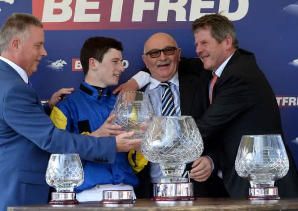 Jockey Oisin Murphy (left) owner Tony Byrne and trainer Joseph Tuite (right) celebrate after Litigant winning the Betfred Ebor Handicap at York in August.