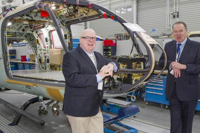 COMING SOON: Peter Sunderland, left, and Bruce Burns with the new helicopter