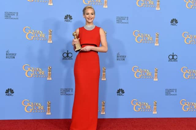 When in doubt, bold red may well win the day - Jennifer Lawrence poses with the award for best actress at the  Golden Globe Awards. (Photo by Jordan Strauss/Invision/AP)