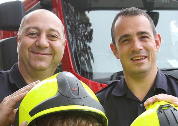 Giovani Richetta, left, pictured with firefighter Danny Pepper in Brighouse.