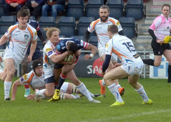 Andrew Bulumakau of Doncaster Knights tries to break the Yorkshire Carnegie tacklers as he charges towards the try line.