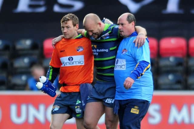 Carl Ablett is helped off the pitch after picking up an ankle injury.