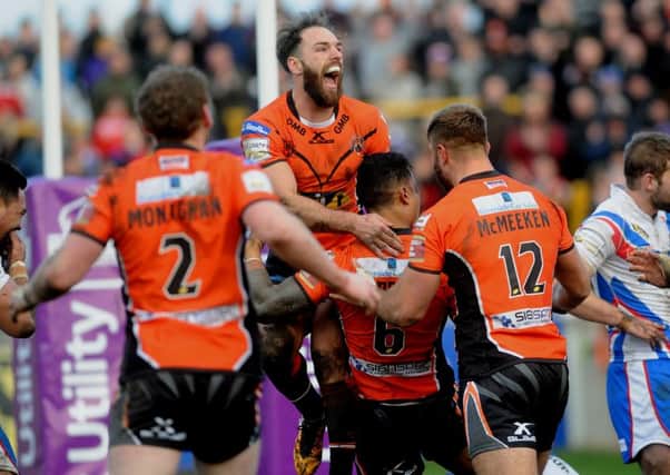 Castleford players congratulate Ben Roberts after his try against Wakefield.