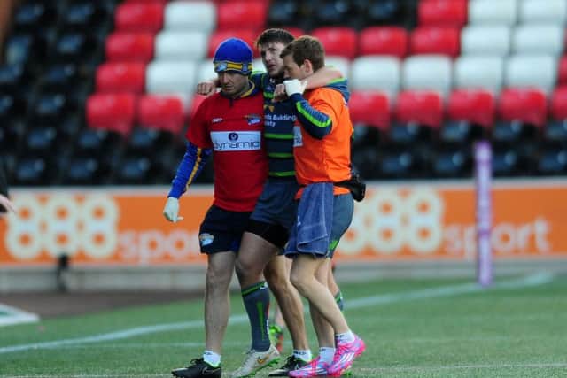 Tom Briscoe is helped from the field at Widnes.