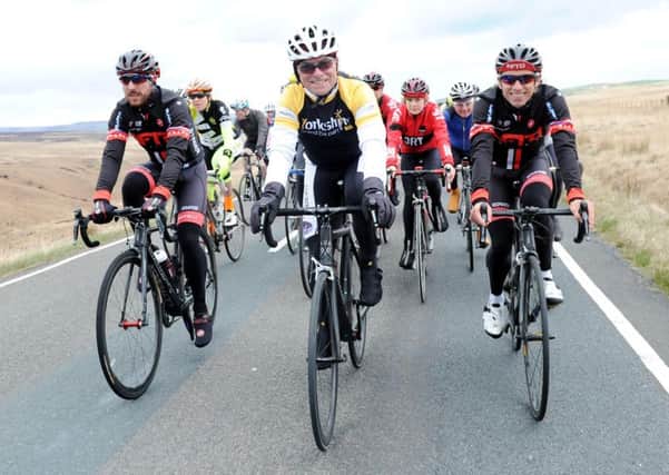 Tour de France legend Bernard Hinault with Yorkshire cyclists Dean and Russ Downing. Pic: SWPIX.COM