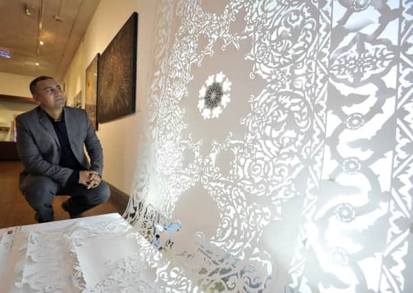 Mobeen Butt, exhibition curator and  founder of the Muslim Museum Initiative, looks at "Magic Carpet" by Maryam Golubeva as part of the 'Faith in Art' expo at Craven Museum in Skipton.   Picture: Bruce Rollinson.