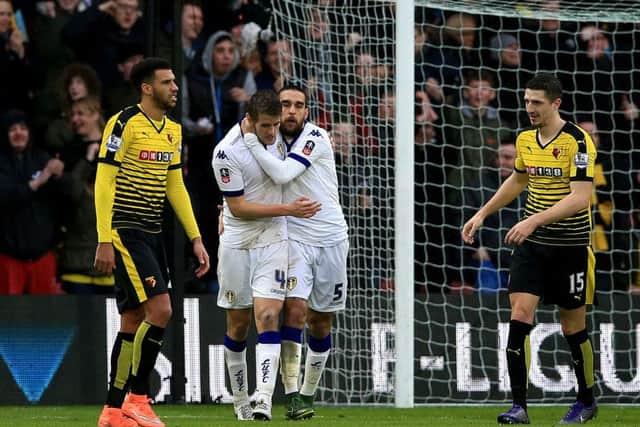 Leeds United's Scott Wootton is consoled by Giuseppe Bellucci  after scoring an own-goal against Watford.