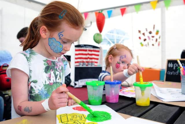 Niamh and Poppy Lydon painting in the kids tent at the Leeds Feast. Picture by Jonathan Gawthorpe.