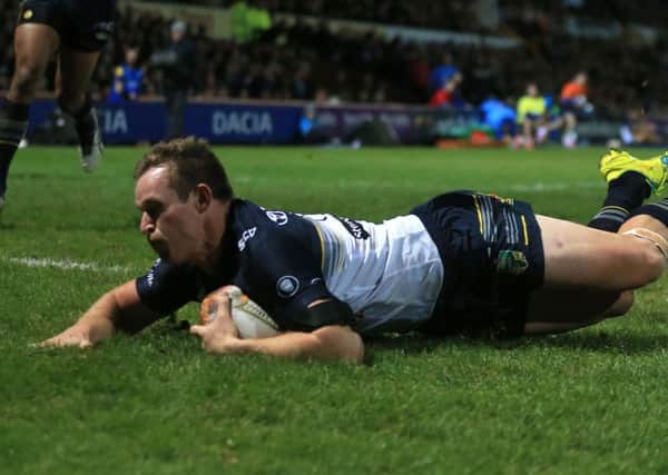 North Queensland Cowboys' Michael Morgan dives in to score his side's first try of the game during the World Club Challenge.