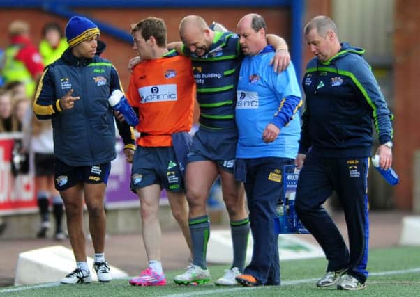 Carl Ablett is helped off after suffering an ankle injury at Widnes.