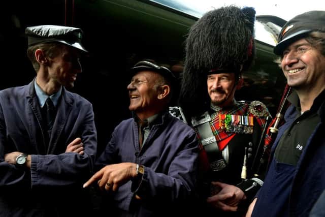 The crew that brought Flying Scotsman into York station, left to right, Jim Clarke (Fireman), Jim Smith (Footplater superintendent) and Steve Hanczao (Driver) in the background is Piper David Watertoon-Anderson who piped in the steam engine. (GL1009/09q)