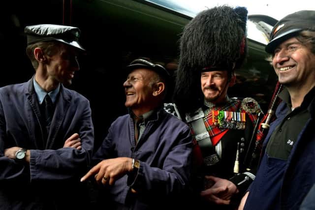 The crew that brought  Flying Scotsman into York station, left to right, Jim Clarke (Fireman), Jim Smith (Footplater superintendent) and Steve Hanczao (Driver) in the background is Piper David Watertoon-Anderson who piped in the steam engine. (GL1009/09q)