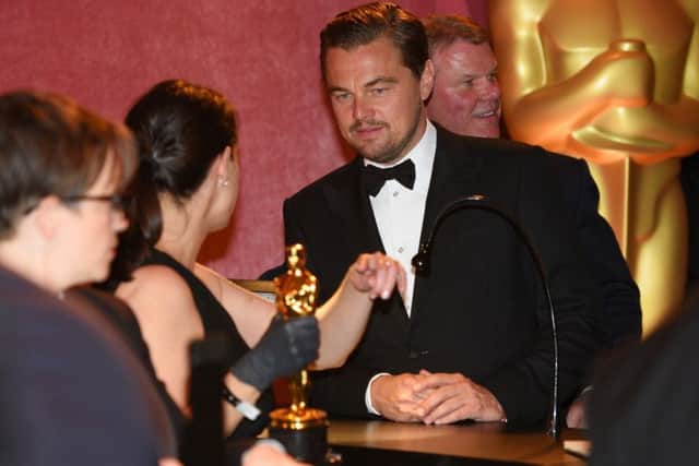 Leonardo DiCaprio, winner of the award for best actor in a leading role for The Revenant, gets his Academy Award engraved at the Governors Ball after the Oscars