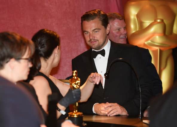 Leonardo DiCaprio, winner of the award for best actor in a leading role for The Revenant, gets his Academy Award engraved at the Governors Ball after the Oscars