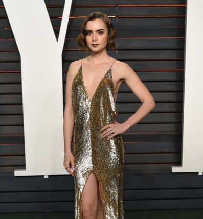 Lily Collins arrives at the Vanity Fair Oscar Party, looking fabulously aglow. Photo by Evan Agostini/Invision/AP