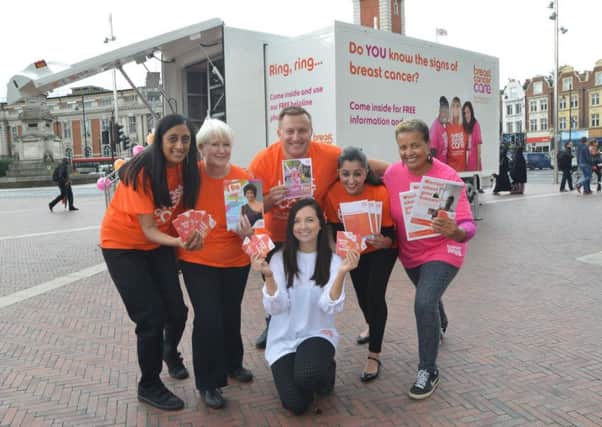 Volunteers outside the breast cancer roadshow bus.
