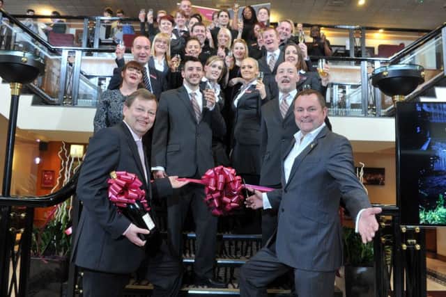 General manager Marco Frik, staff and Sir Gary Verity celebrate the reopening of the Crowne Plaza. Picture by Tony Johnson.