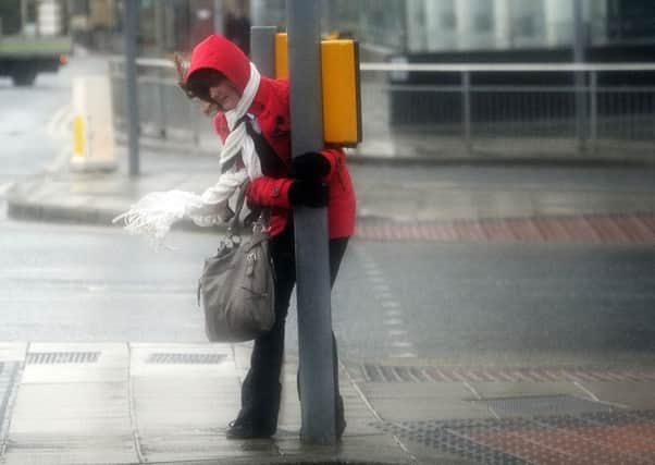 A pedestrian struggles during previous stormy conditions at Bridgewater Place.