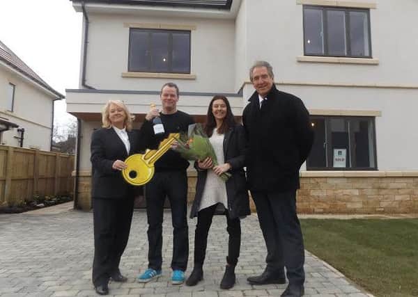 Jamie and Joanne Powell (centre) with sales negotiator Carol Quilliam and Steve Edwards, construction director.
