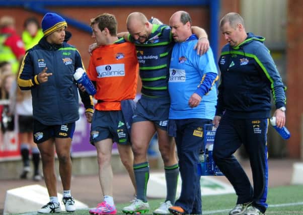 Carl Ablett is helped off the pitch at Widnes.