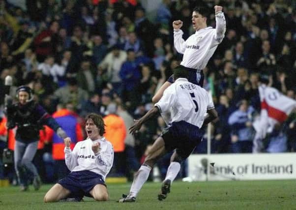 Leeds United's Ian Harte, back, Lucas Radebe, front right, and Harry Kewell, left, celebrate Kewell's goal for Leeds United against AS Roma.